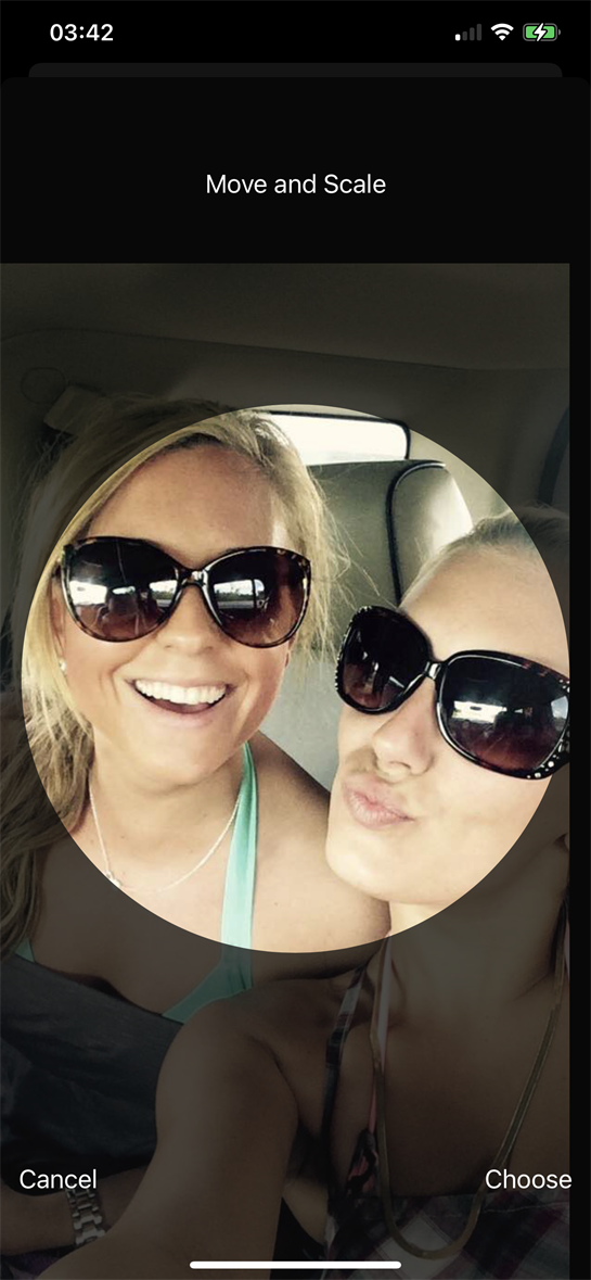 Two friends enjoy each other's company in a car, smiling brightly while wearing stylish sunglasses.