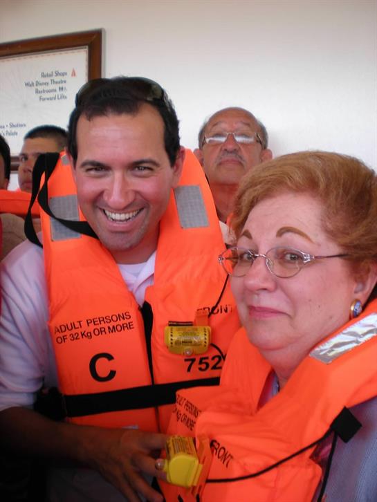 Individuals participate in a safety briefing wearing life jackets, showing smiles and excitement.