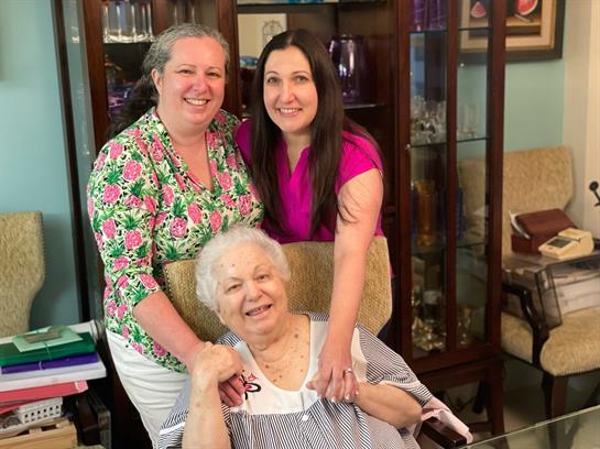 Family members celebrate together in a warm home, smiling and enjoying precious moments.