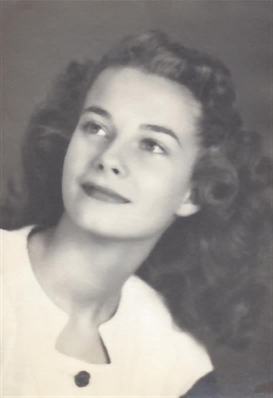 A young woman with curly hair looks away softly, evoking a sense of nostalgia in her expression.