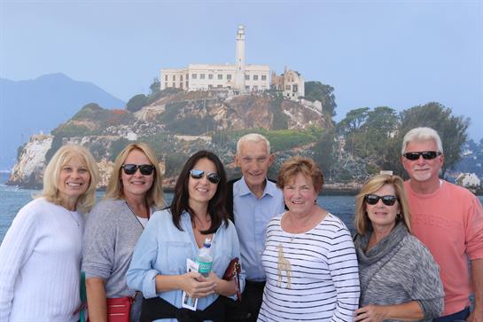 Group of six individuals enjoying the view of Alcatraz Island and sharing a moment together.