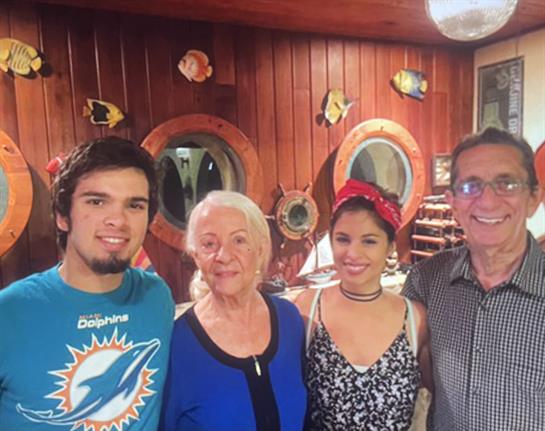 A joyful family enjoys their time together in a charming restaurant with wooden decor.