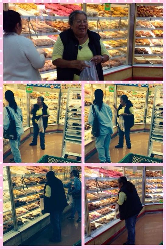 People explore a bakery filled with colorful pastries and baked goods, enjoying their time.