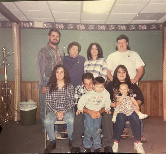 Family members gather in a cozy room, enjoying each other's company and making memories.
