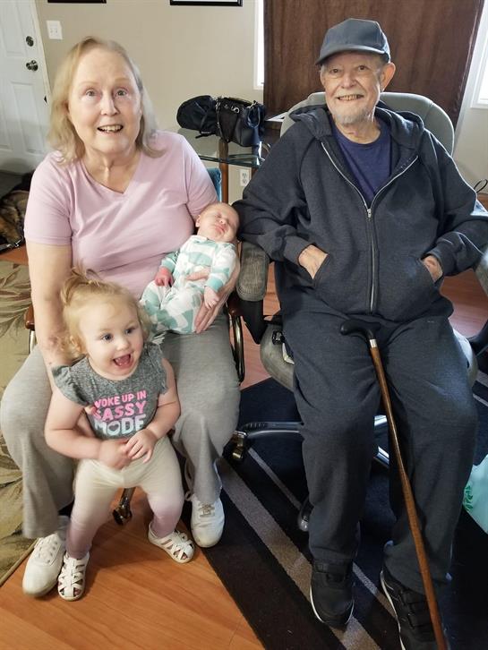 Grandparents and grandchildren share joyful moments in a warm family environment.