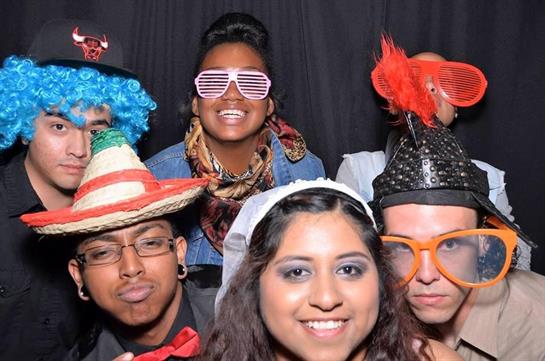 Friends dressed in vibrant costumes enjoy a fun night at a lively costume party.