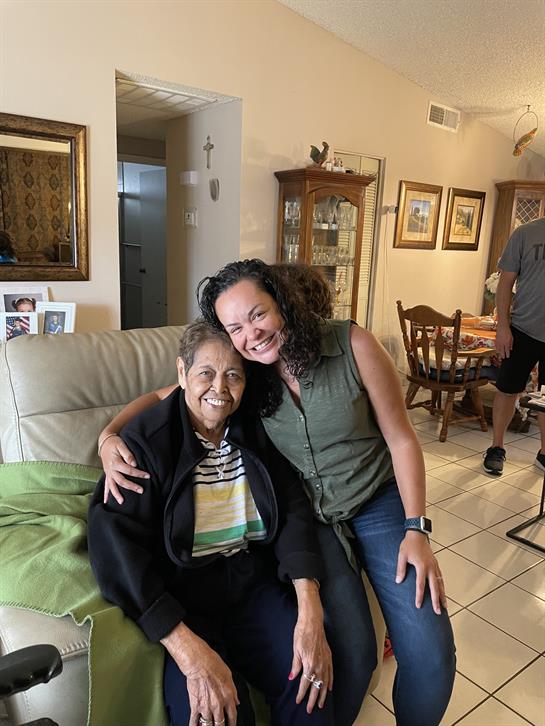Grandmother and granddaughter enjoy quality time together in a cozy living room setting.