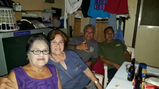 Four friends laugh and share stories in a cozy, relaxed setting.