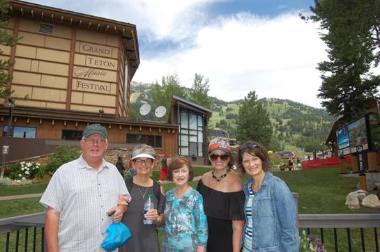 Friends gather for a fun day at the festival, showcasing mountain scenery and bright weather.