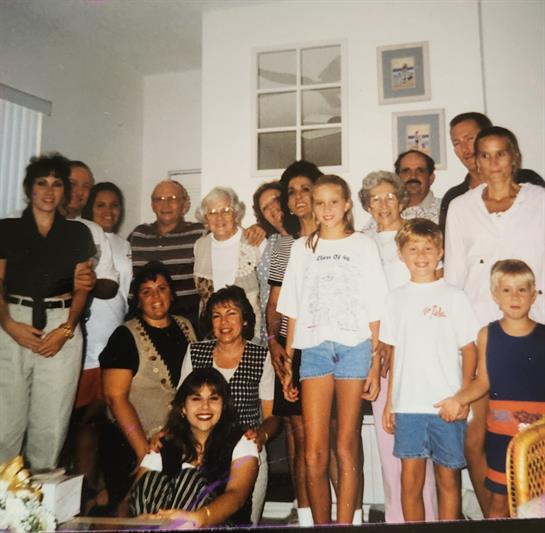 Group of family members joyfully posing together in a warm, inviting living room.