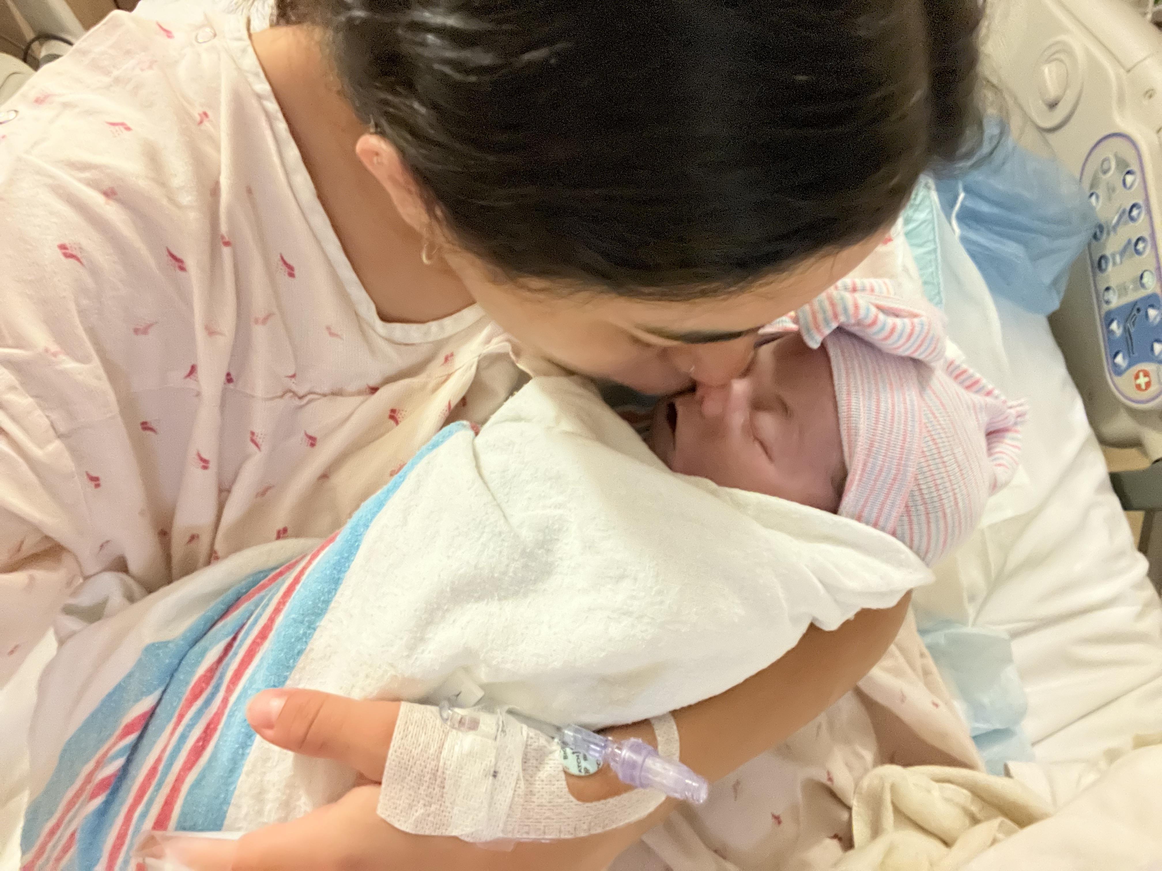 A woman kissing a baby