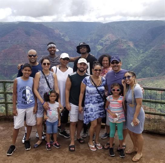 Friends and family gather at a scenic mountain viewpoint, sharing smiles and joy.