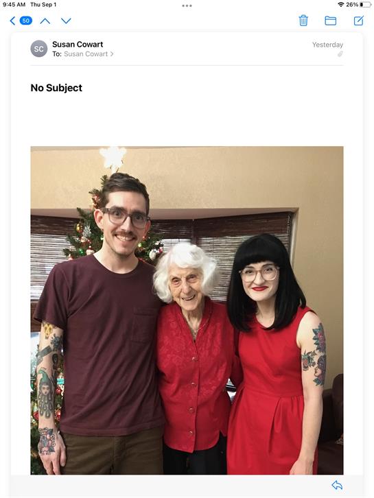 Three family members with joyful expressions pose together, celebrating the holiday season.