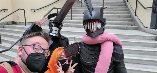 Group of friends showcase their unique costumes and makeup during a lively cosplay gathering.