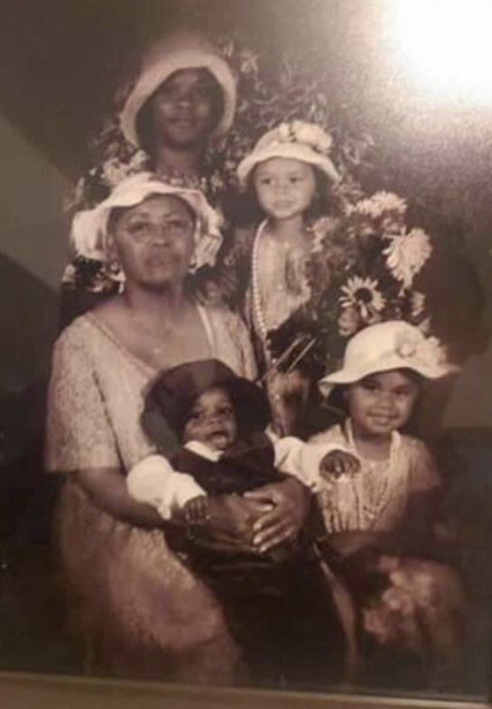 A joyful family gathering showcases love across generations, with children in festive hats.