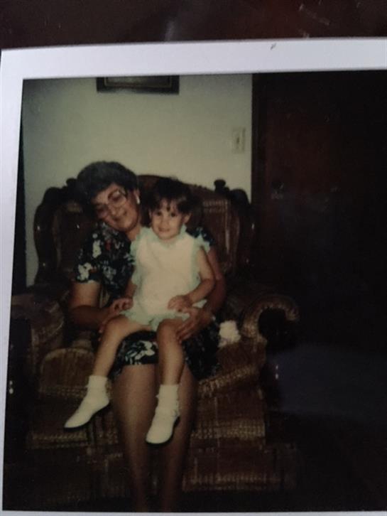 A joyful moment of a grandmother and granddaughter together in the living room.