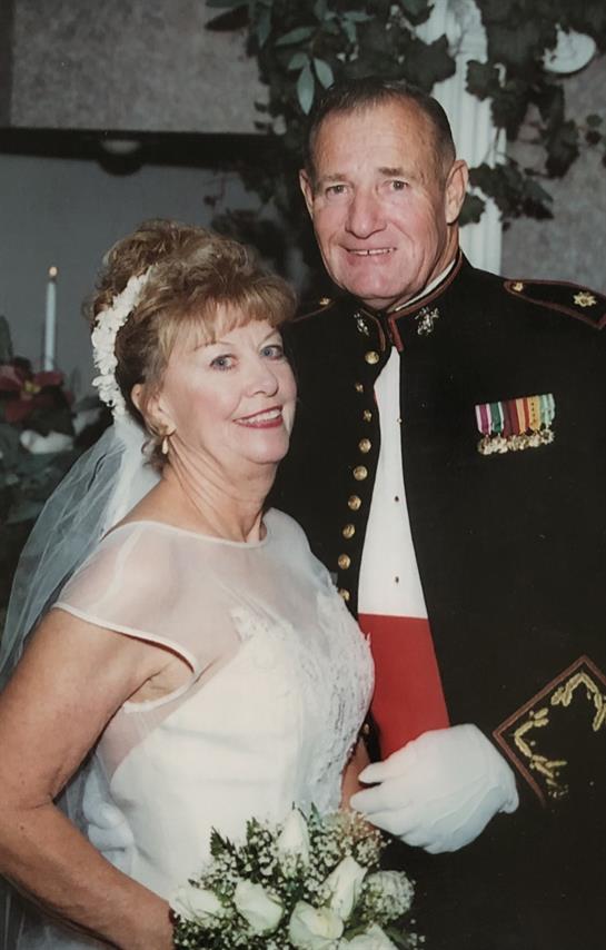 Wedding couple poses joyfully, showcasing their formal attire and happiness during the celebration.