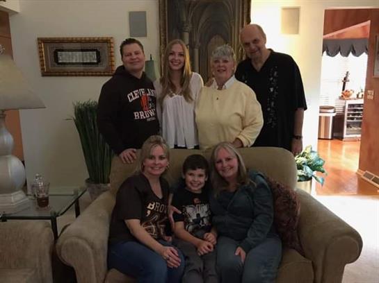 Family members gathered in a warm living room, smiling and enjoying quality time together.