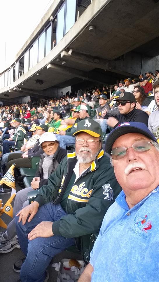 Group of fans share smiles and excitement in the stadium, enjoying a baseball game together.