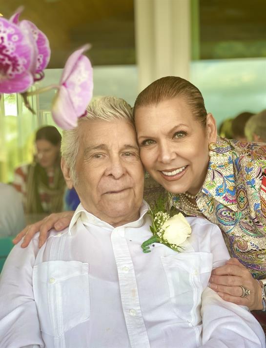 Loved ones joyfully celebrate a cherished elder at a heartfelt, laughter-filled event.