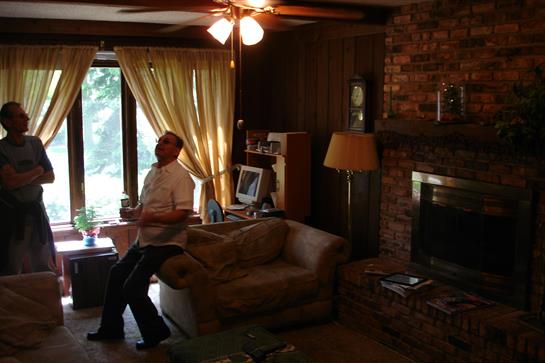 A man relaxes in a sunny, cozy living room with a rustic vibe.
