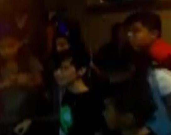 A group of people gathers to enjoy live music while celebrating at a street festival.