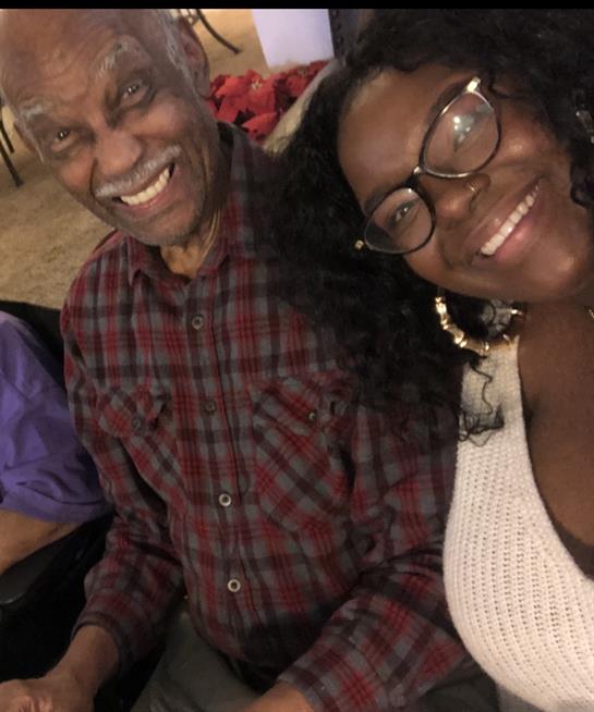 Two people enjoy each other's company, smiling and socializing at a cheerful gathering with friends.