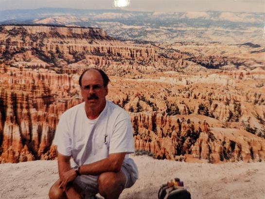 A man poses while appreciating the vast rock formations in Bryce Canyon National Park.