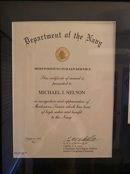 A certificate recognizes Michael J. Nelson's contributions to the Navy and civil service.