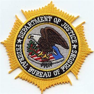 The Federal Bureau of Prisons badge shows an eagle with a shield, symbolizing law enforcement.