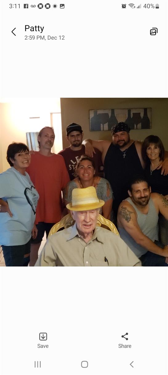 A group of family members poses together in a cozy living room, enjoying time together.