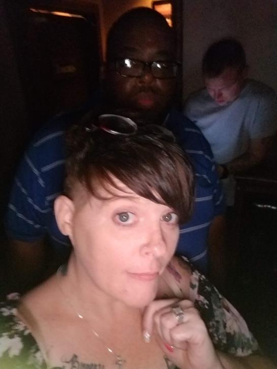 Group of friends relax and interact during a fun evening gathering indoors, sharing smiles.