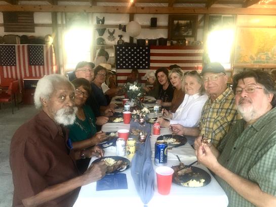 Friends and family share a hearty meal in a cozy, rustic environment filled with warmth.