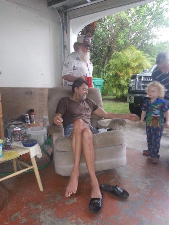 A casual gathering occurs with family members enjoying a rainy afternoon outside.