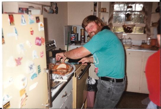 Person is preparing food in a cozy kitchen filled with utensils and home appliances.