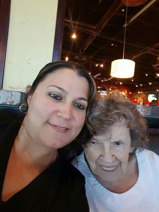 Women share smiles and conversation in a relaxed restaurant atmosphere.