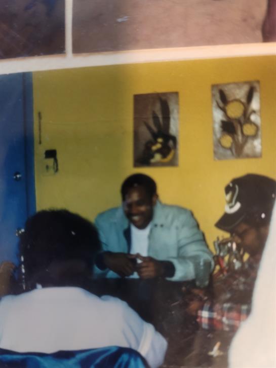 Friends share laughter and stories in a vibrant room filled with art and warmth.