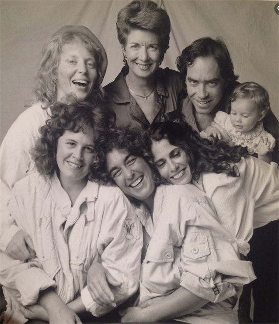 Group of happy friends and family members share laughter and smiles, showcasing close relationships.