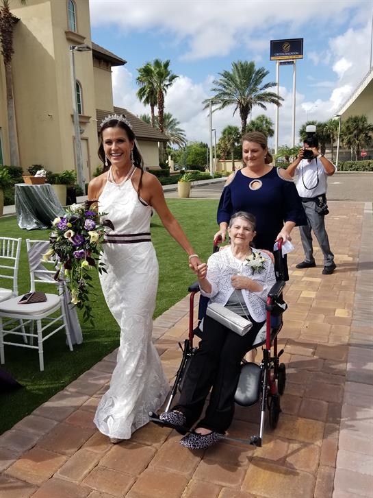 Celebration of love where a bride walks joyfully with her grandmother, filled with happiness.