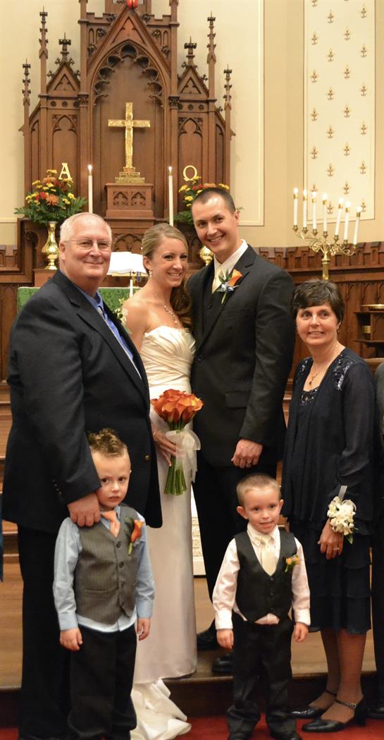 Family members celebrate a wedding in a charming chapel, capturing warm smiles and happiness.