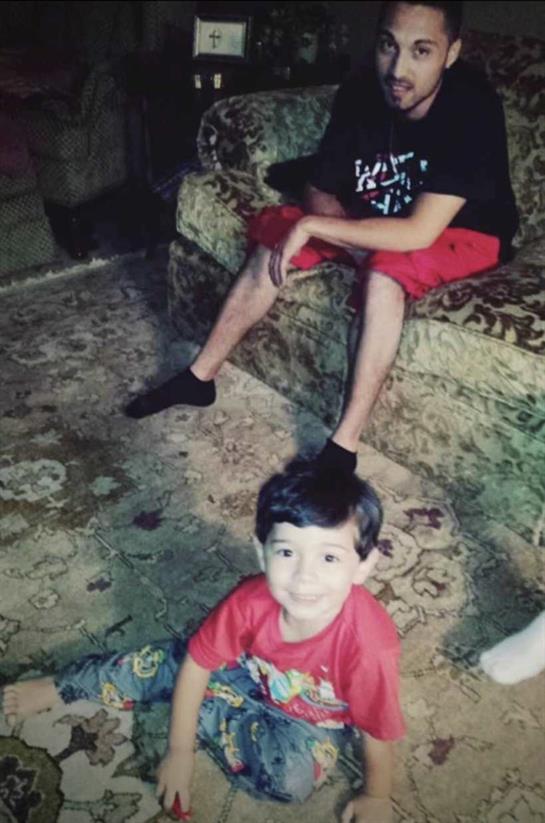 Two kids relax indoors; one on the floor and the other on a couch, creating a cozy vibe.