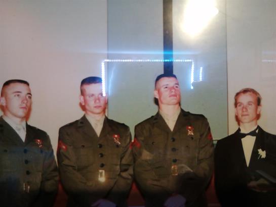Four men in military uniforms are standing together, showcasing camaraderie at a formal event.