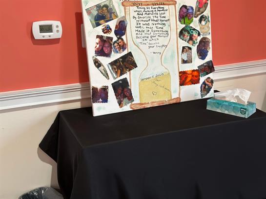 A decorative board with photos and notes highlights cherished memories at a family gathering.