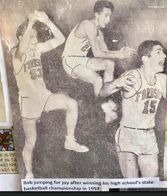 Several basketball players leap high, showcasing athletic skills in an energetic game.