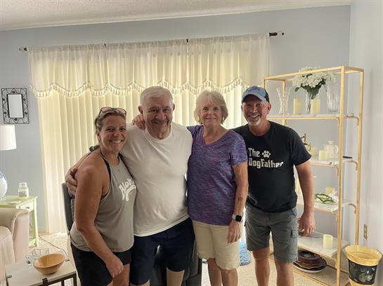 Friends and family gather in a bright living room, sharing laughter and creating lasting memories.