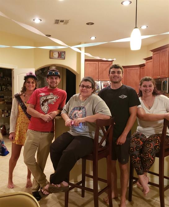 Friends laughing and relaxing together in a cozy kitchen.