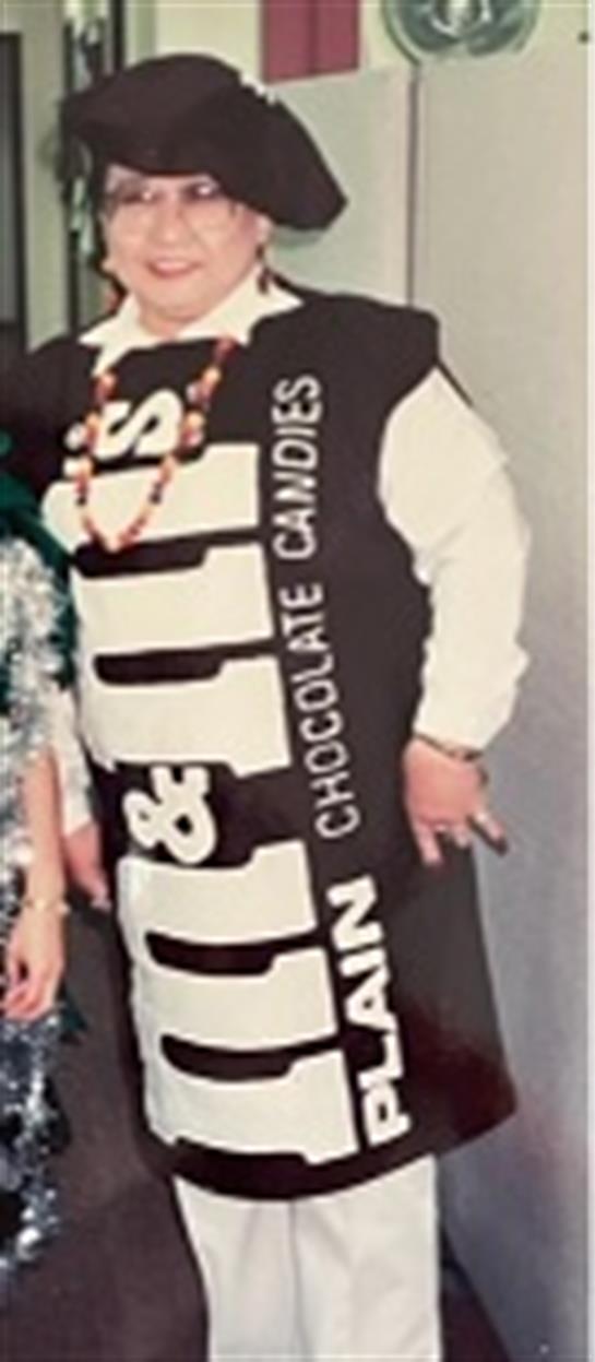 Attendees wear unique outfits, including a chocolate-themed costume, at a fun gathering.