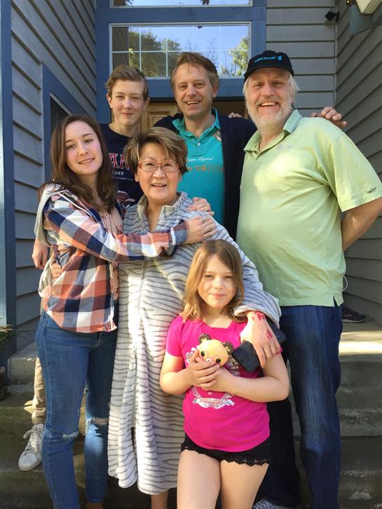 A warm family gathering takes place on a porch, capturing smiles and bonds among relatives.