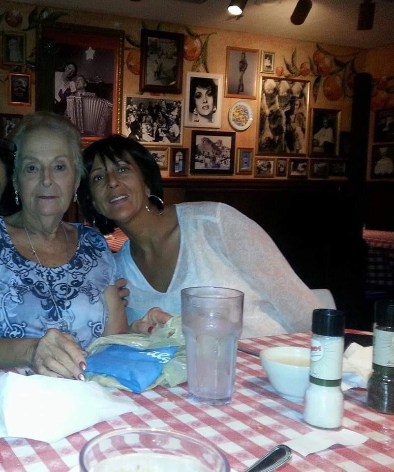 Two women enjoy a meal together in a warm, decorated restaurant filled with nostalgia.