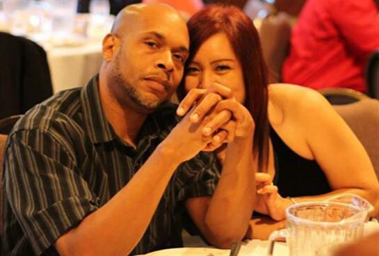 Two people enjoy a close moment at a restaurant, smiling and sharing laughter during dinner.